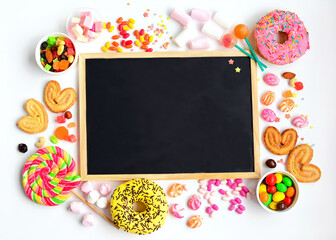 Multi-colored appetizing sweets on a white background with a frame for your text. Top view