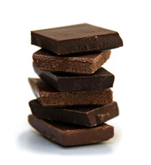 Chocolate cubes, milk and dark, bitter chocolate bar pieces on white background, close-up view.