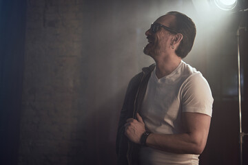 cinematic photo shoot of the confident actor celebrity look in foggy loft room