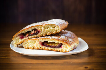 sweet baked homemade plum cake with icing sugar
