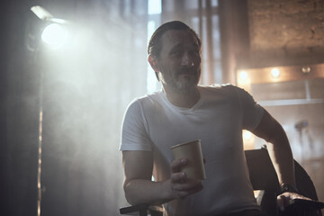 cinematic photo shoot of the confident actor celebrity look in foggy loft room