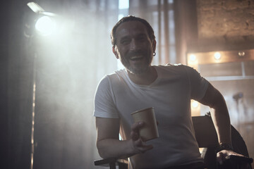 cinematic photo shoot of the confident actor celebrity look in foggy loft room