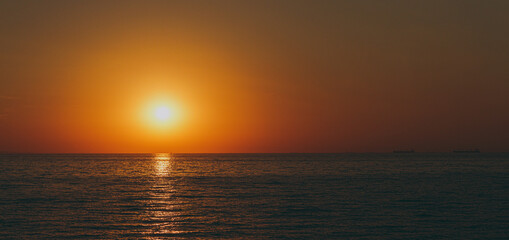 The beautiful sky background at sunrise or sunset on the waterfront sea shore in summer.