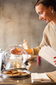 Woman Selling Cookies in a Bakery