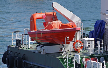 orange lifeboat on ship