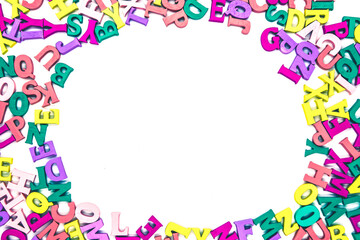 Fototapeta na wymiar Multicolored background of wooden letters Latin alphabet with oval space in the center on white background. Blank to insert text. Concept: back to school, literacy and reading, language learning