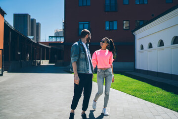 Emotionally man and woman dressed in cool fashionable wear enjoying live communication and day...