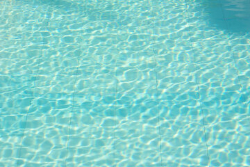 Fototapeta na wymiar Blue water in swimming pool background 