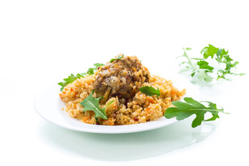 boiled bulgur groats with vegetables and meatballs in a plate