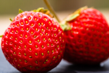 Close up of fresh strawberries showing seeds achenes. Details of fresh ripe red strawberries. © Vlad Ispas