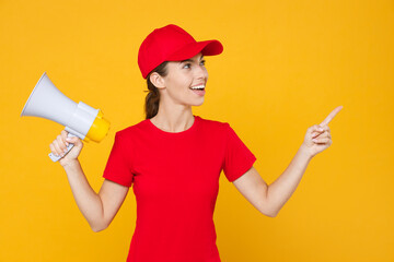 Fun crazy delivery employee woman in red cap blank t-shirt uniform work courier in service hold...
