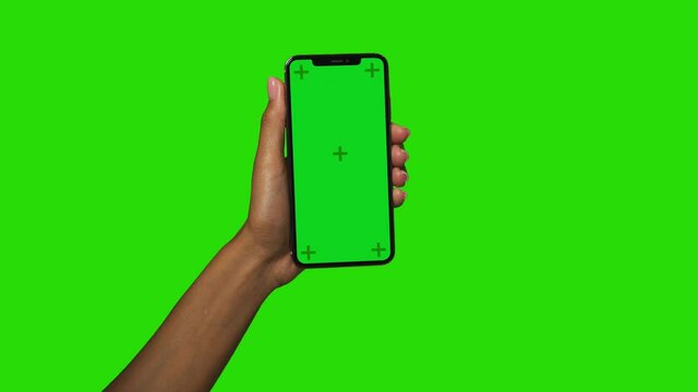 Woman Holding  Smartphone in Black female hands with trackers on the screen and Chromakey Green screen background