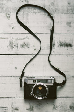 Overhead View Of Analog Camera On The Wooden Background