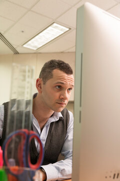 Male Office Worker Looking At A Computer Screen