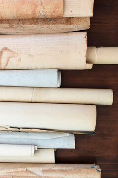A row of antique scrolls on a table.