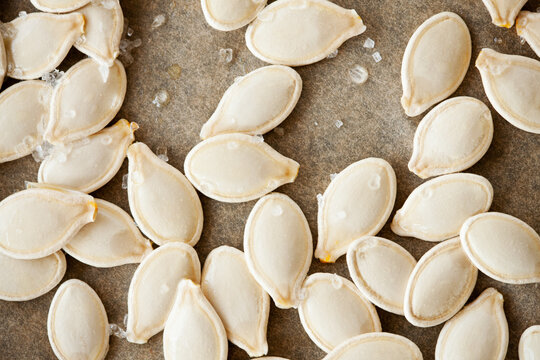 Raw Pumpkin Seeds with Salt on Parchement Paper
