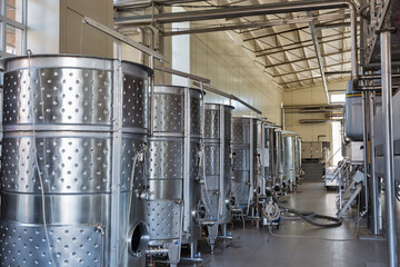 Stainless steel reservoirs for wine at modern winery, Ukraine.