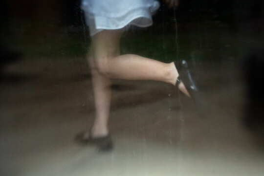 Girl in white dress running appearing translucent and spirit like