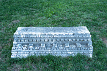 NIN, CROATIA - june 2020 - Part of Roman architrave on the green grass. Architrave or epistyle is...