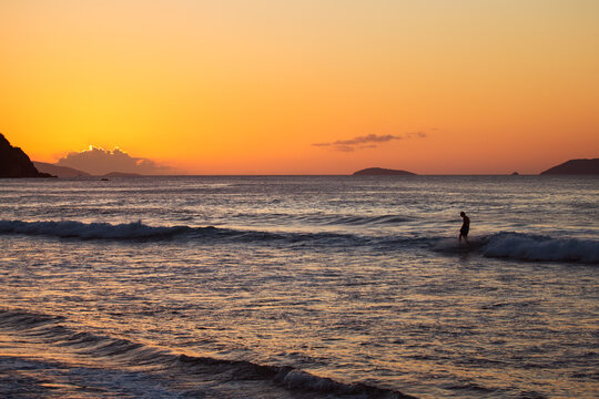 Surfer on the sea at sunset