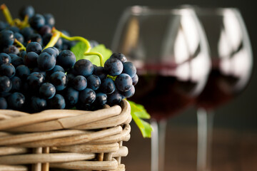 Freshly picked grape with red wine glasses