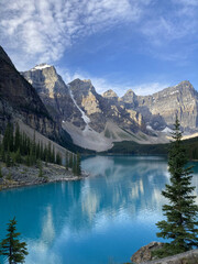 Naklejka na ściany i meble Beautiful blue lake with rocky mountains and trees
