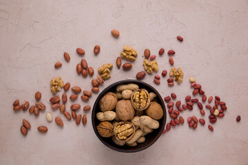 Peanuts, walnuts in a cup. Nut diet, healthy food. View from above