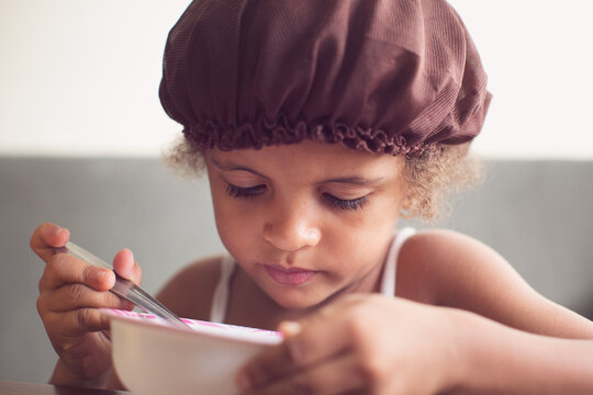 Portrait of a young girl having a bowl of cereal for breakfast