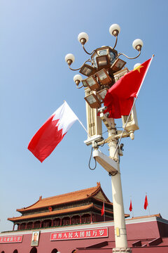 tall square lights and flags in front if Tiananmen