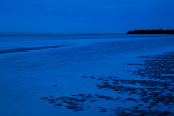 Fototapeta na wymiar Blue hour on a beach on the Belgian coast on a summer night.