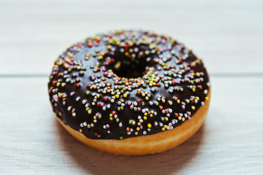 Donut with Chocolate Icing and Colorful Sprinkles