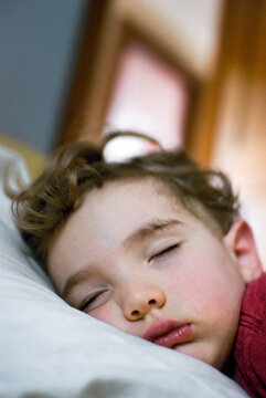 Toddler boy sleeping in the afternoon with his face squished into the pillow