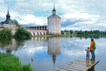 Tourist family mother and son looking at famous Kirillo-Belozersky monastery near Vologda city. Local travel in Russia North.