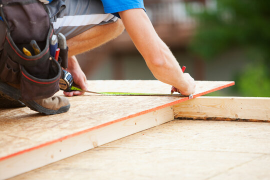 Construction: Framer Making Measurement Mark with Pencil