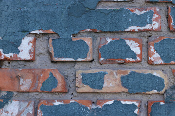Old brick wall with cracked blue paint copy space for design or text, horizontal orientation
