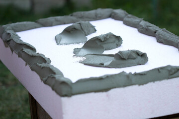 Wall insulation with polystyrene panels, glue application and installation.