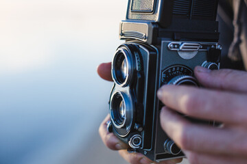 Man taking a photo with an old camera