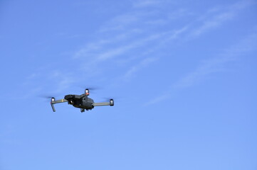 Fototapeta na wymiar Drone flying in the air against the sky. 
