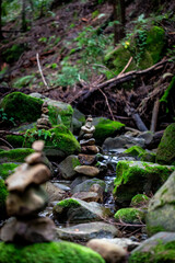 stacked rocks in a stream 
