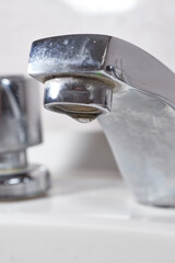 Water tap leaking water drops .Drops and faucet isolated on a white background