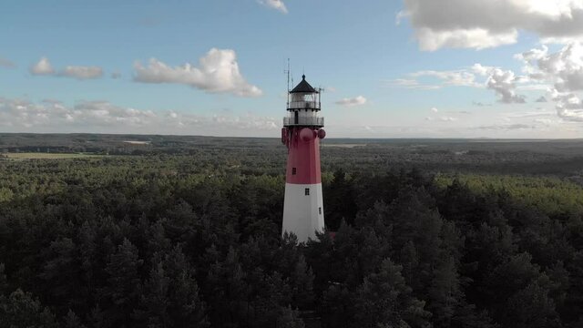 Aerial view of Stilo lighthouse amid pine forest in Osetnik, Poland