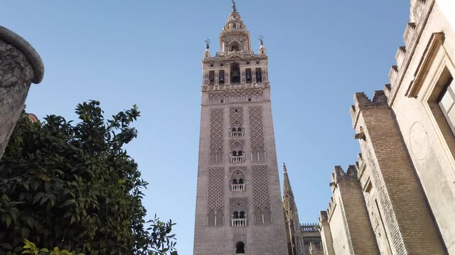 Slow Slide Right, Giralda Bell Tower at Seville Cathedral with Blue Sky, Spain