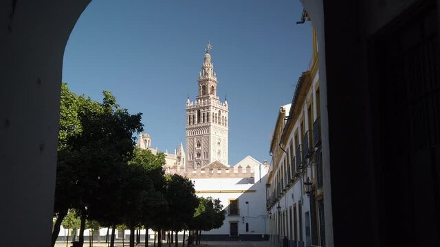 Reveal of Giralda Tower beyond Tunnel from Patio de Banderas, Seville, Spain