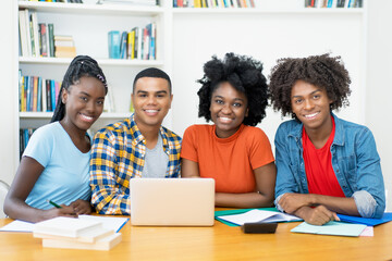 Group photo of african american and latin students at computer