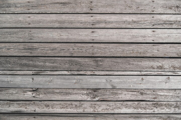 Fototapeta na wymiar Old unpainted wooden planks as horizontal background, wooden floor with cracks and nails