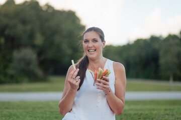 woman having a healthy snack on a picnic