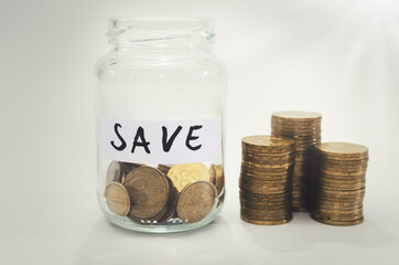 Stacks of money saving coins in a glass jar. Laundering of money. Business growth concept. Stack of coins. Savings for the future concept.