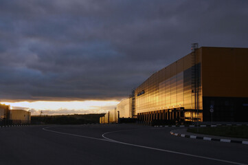 Fototapeta premium Warehouse logistics complex in the rays of the rising sun.