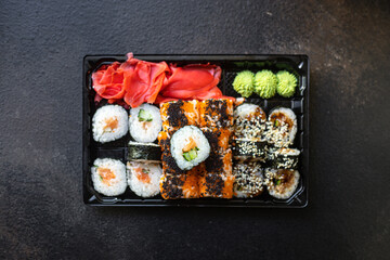 sushi rolls fish salmon, vegetables, ginger wasabi rice and nori on the table serving portion size top view place copy space for text