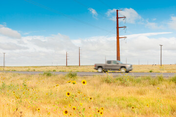 Fototapeta na wymiar Giant power pylons carry power across rural landscape on Route 66 Texas, USA